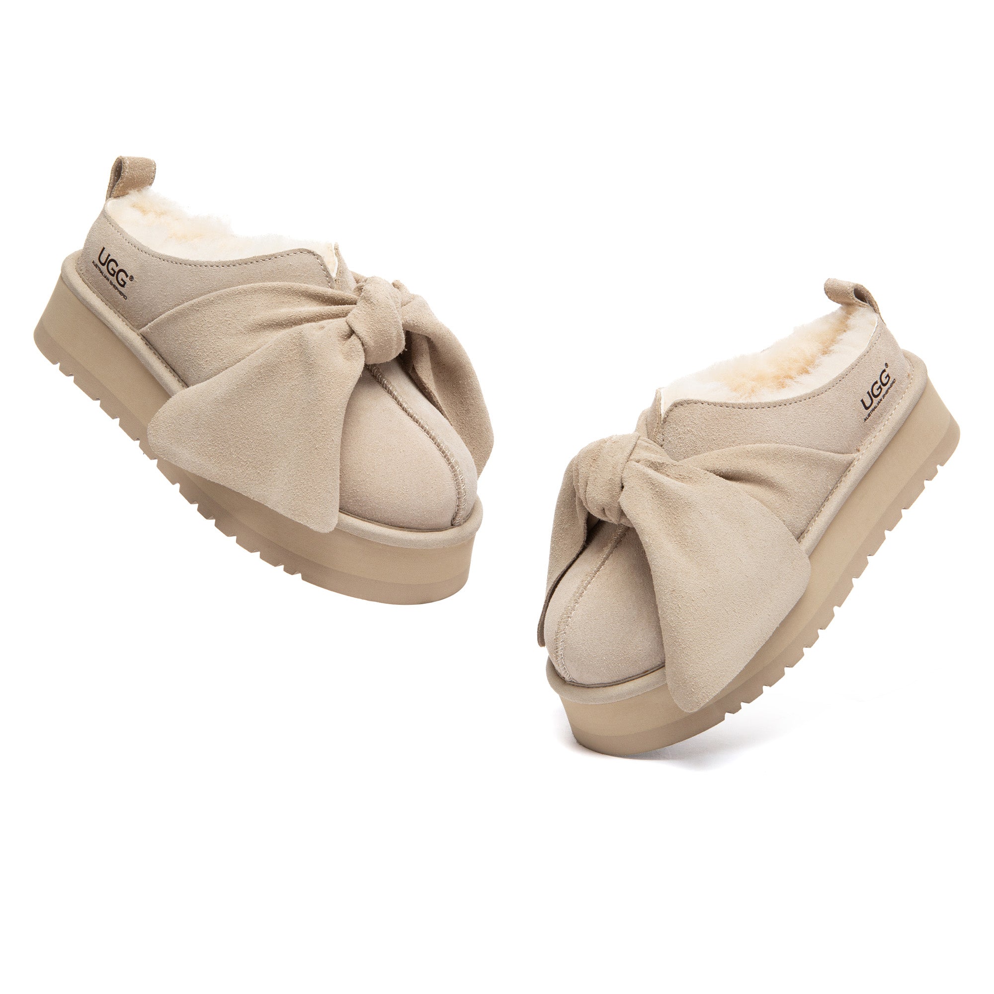 EverUgg Ultra Bow Platform UGG slippers featuring a plush exterior, thick platform sole, and a decorative bow on top.