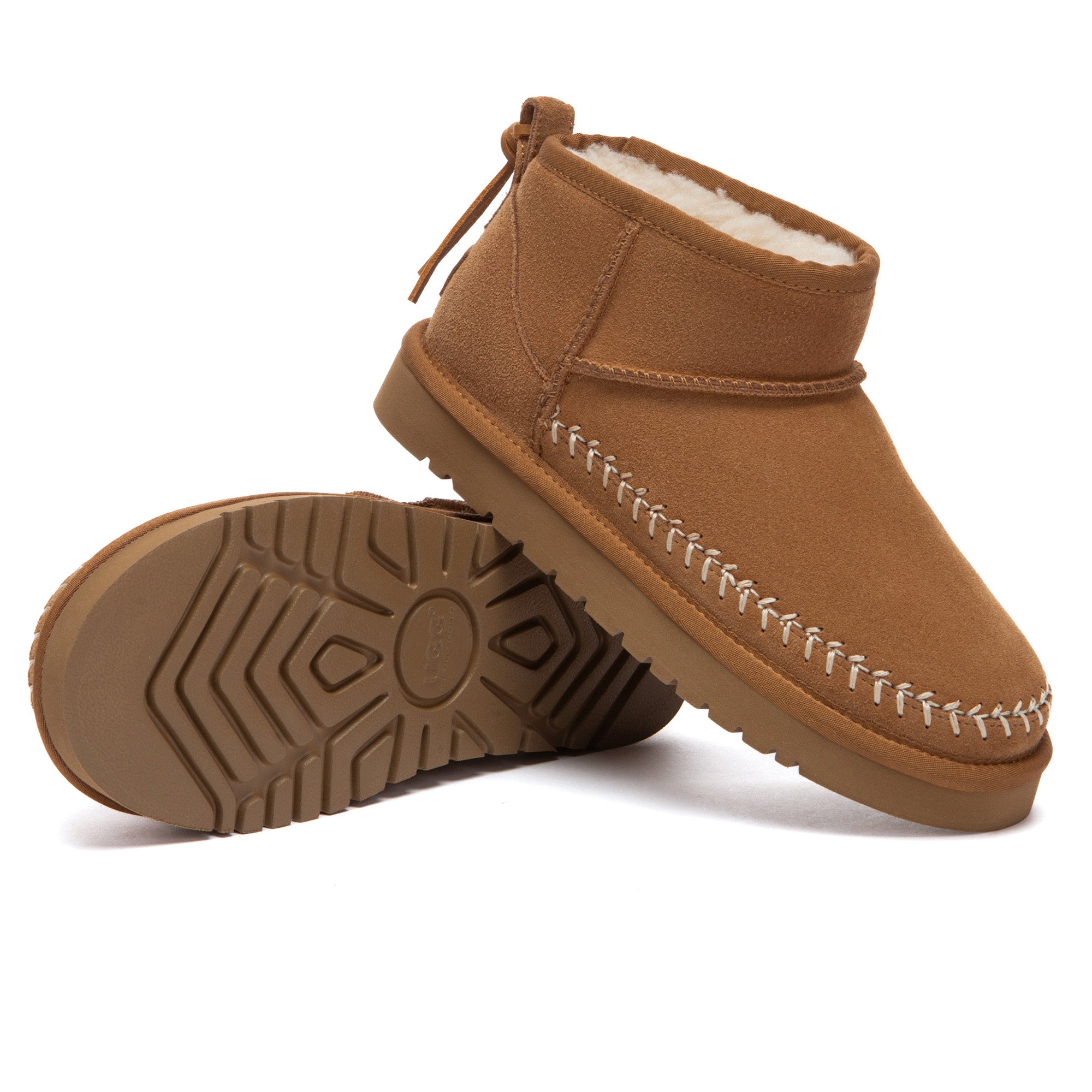 Close-up of beige Stitch Ultra Mini UGG Boots by EverUgg, showing plush interior and soft suede exterior.