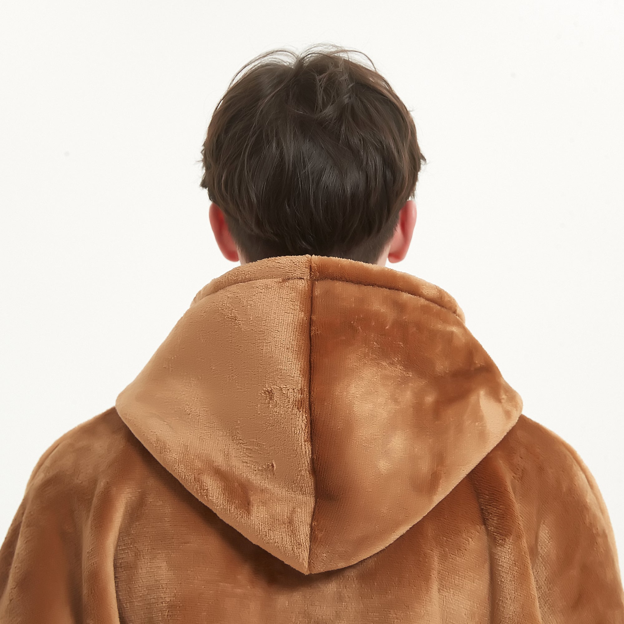 Snuggyz Chestnut Hoodie Blanket draped on a chair, showcasing its cozy hooded design and soft fleece material for warmth.