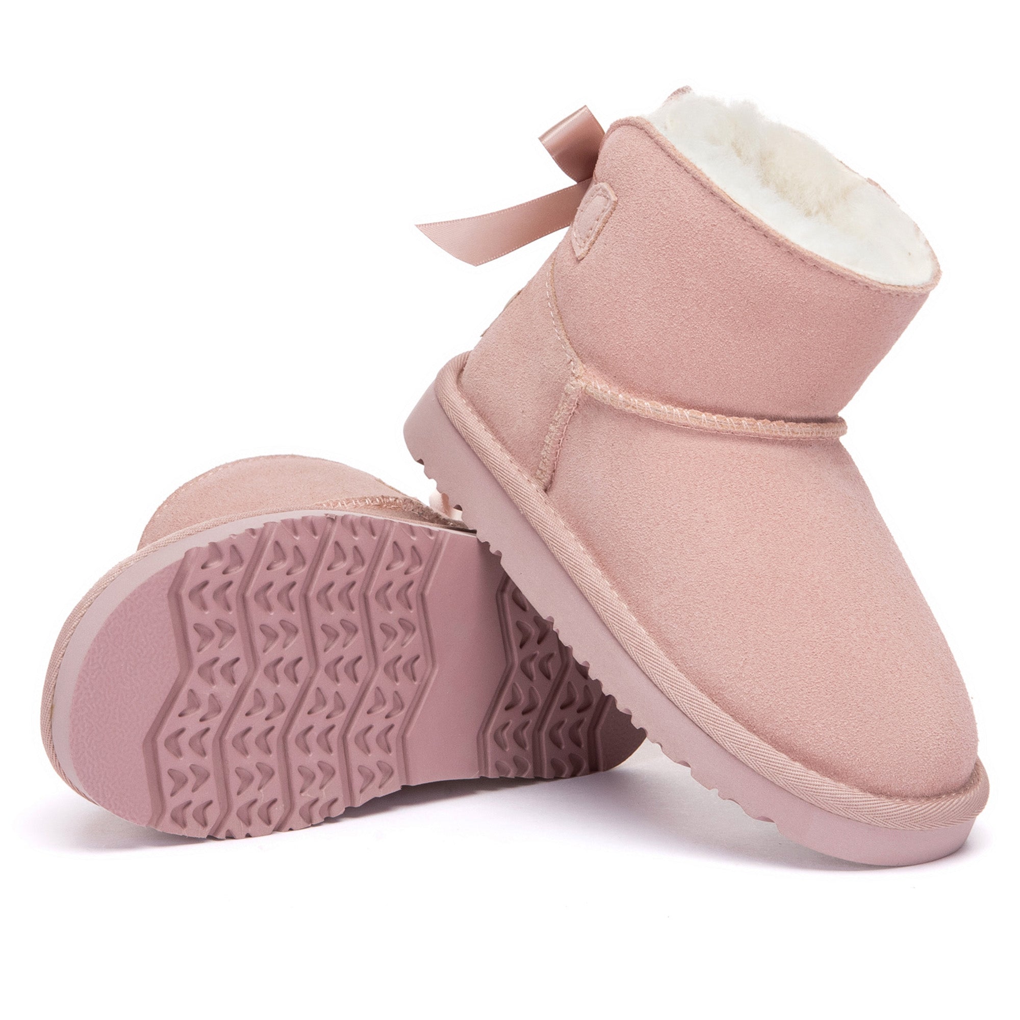 Kids mini classic UGG boots with back bow in tan, featuring soft sheepskin lining and durable rubber sole.