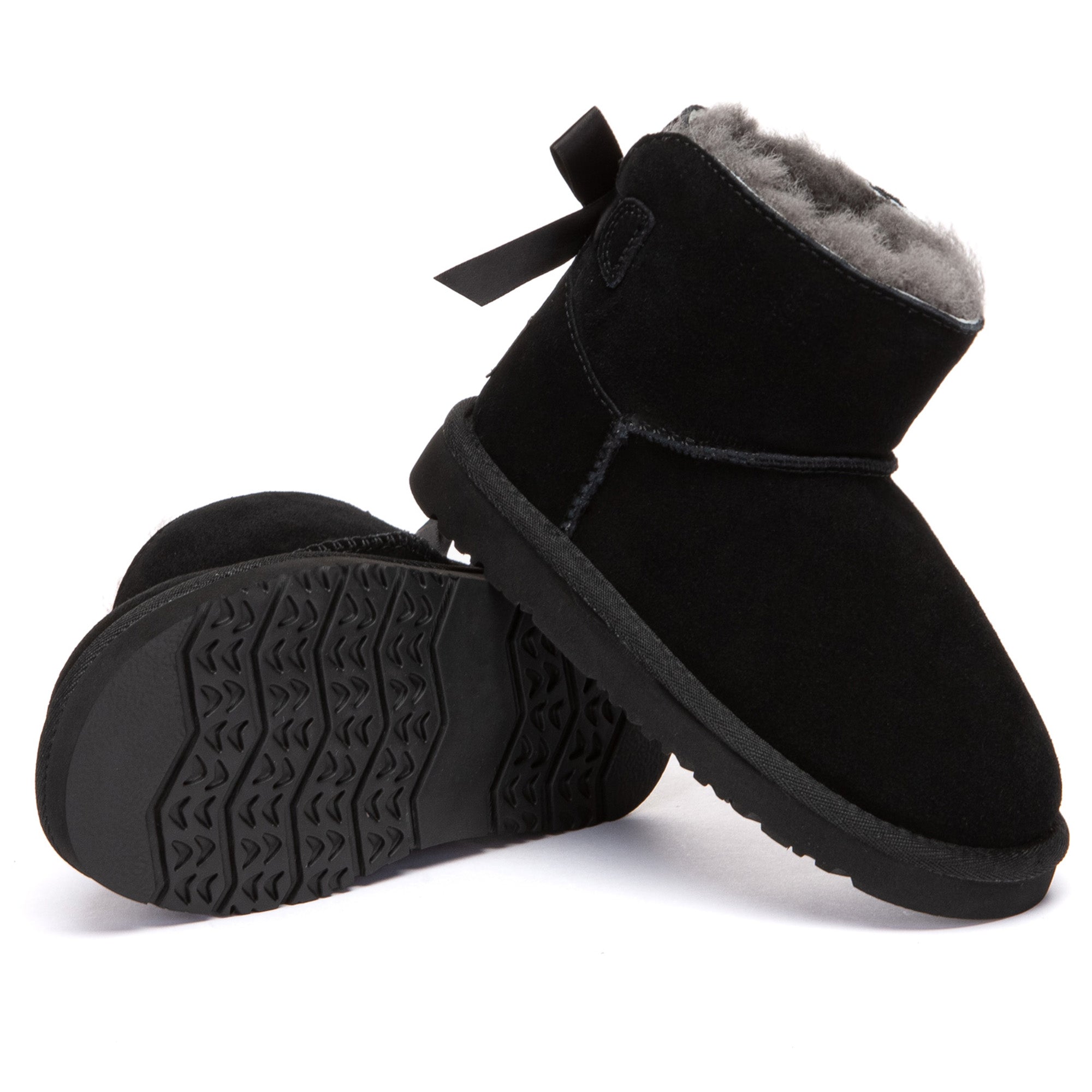 Kids' mini UGG boots with classic back bow in light brown, featuring soft sheepskin lining and sturdy rubber soles by EverUgg.