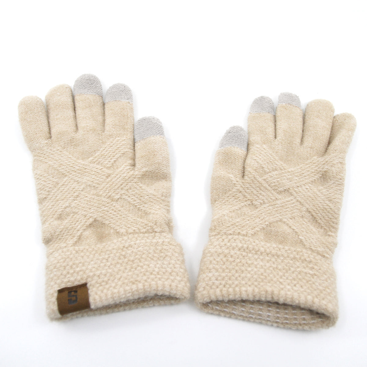 Snuggyz 3-in-1 beanie, scarf, and gloves set displayed with gloves on a chest. Warm accessories for winter comfort.