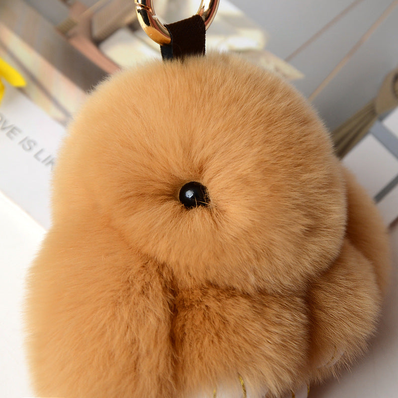 Cute Snuggyz Bunny keychain featuring a plush bunny with pink accents, attached to a silver keyring.