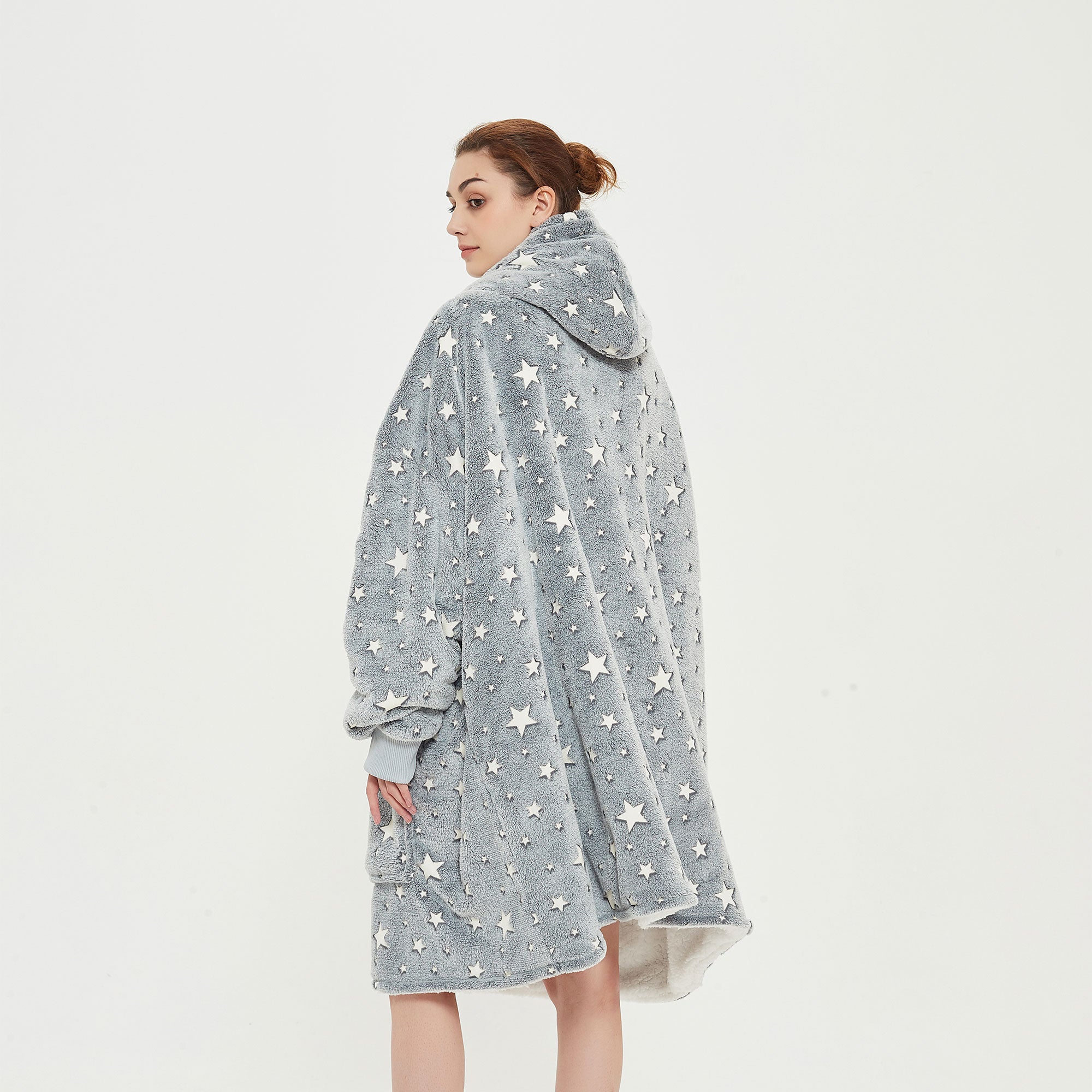 Snuggyz glow in the dark stars hoodie blanket showing a cozy, soft hoodie with star patterns in a relaxed fit.