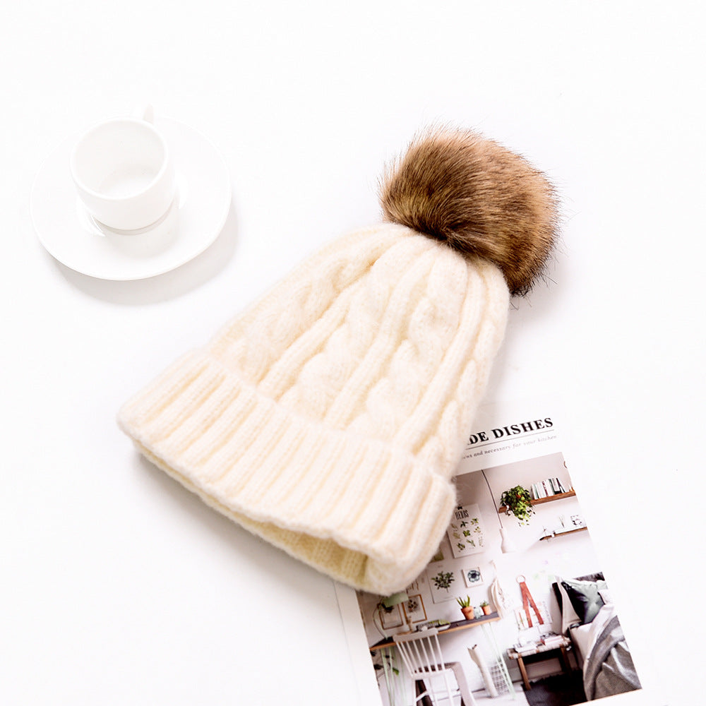 Snuggyz Pom Pom Beanie in cozy knit fabric with a fluffy pom-pom on top, perfect for cold weather.