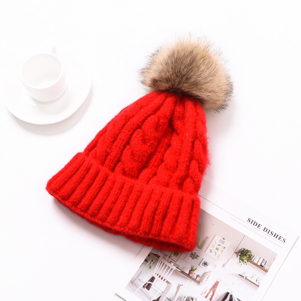 Snuggyz Pom Pom Beanie in cozy knit fabric with a fluffy pom pom on top, perfect for winter accessories.