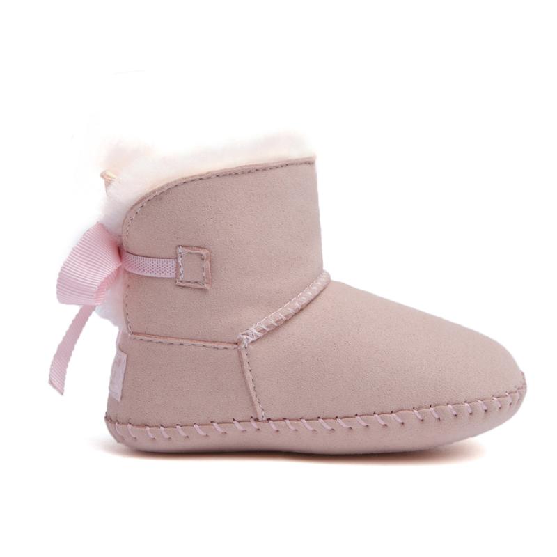 DK UGG stylish baby boots with pearl bow details, soft shoes for kids, showcasing a cozy, fashionable design.