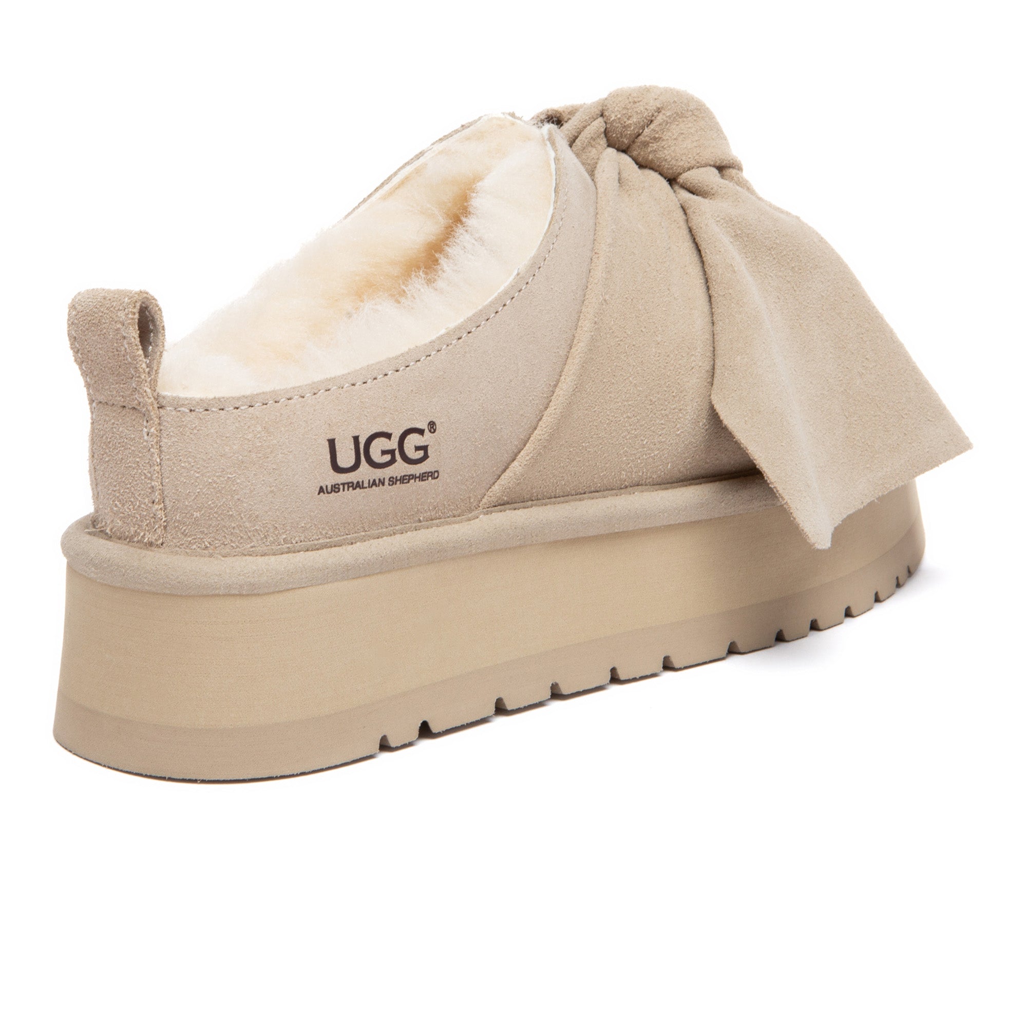 EverUgg Ultra Bow Platform UGG slippers featuring a cozy design with a large bow and elevated sole for stylish comfort.