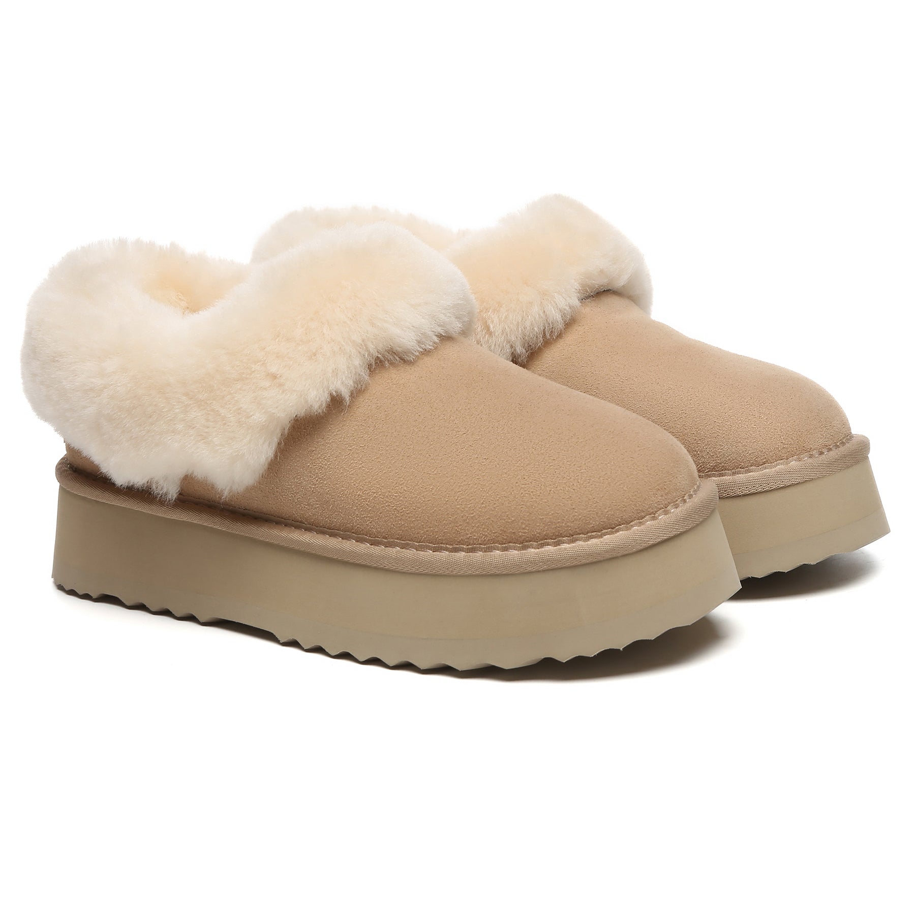 EverUgg Claire UGG platform ankle slippers with soft beige suede and plush lining, displayed on a sandy background.