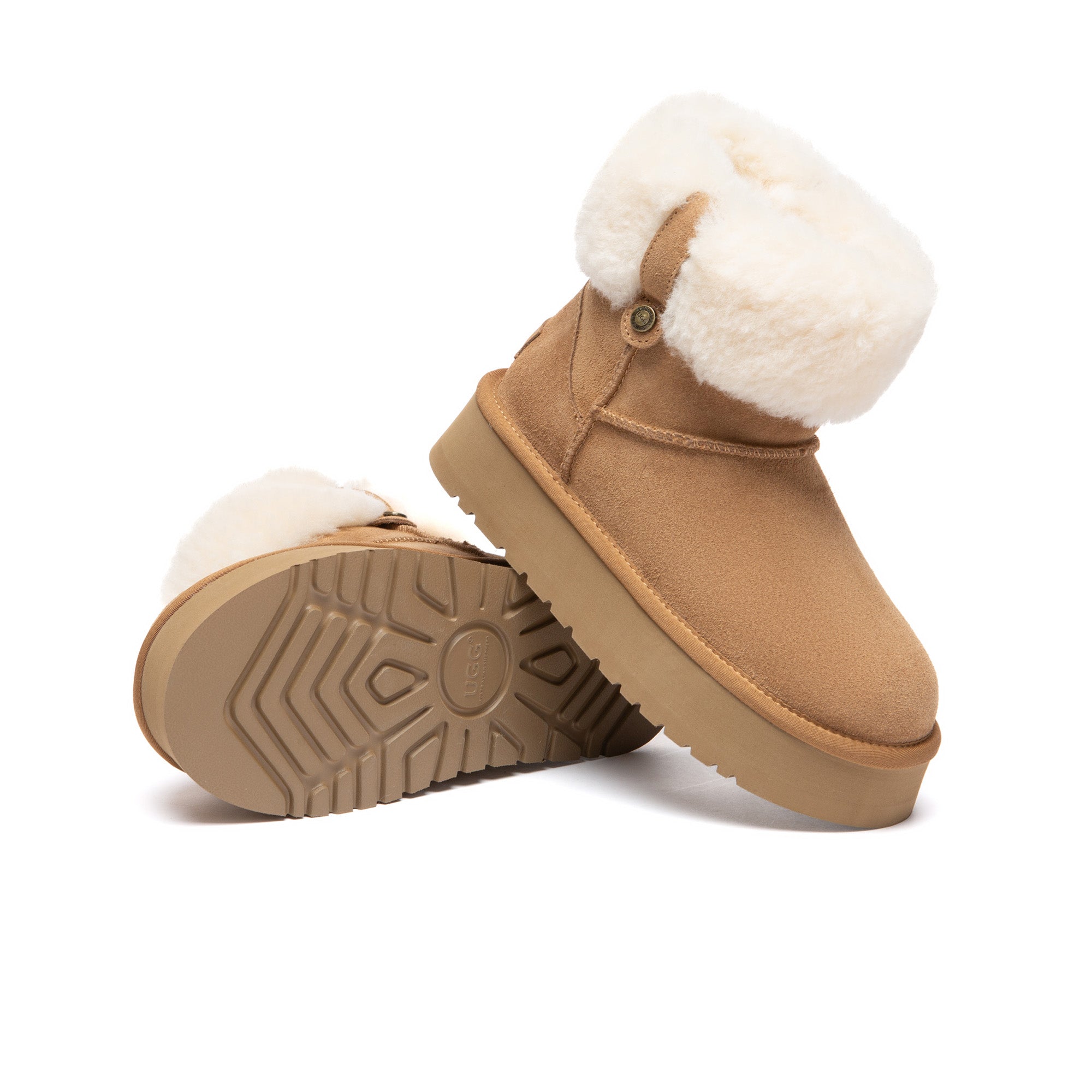 Eleni pull-on mini UGG boots by EverUgg with soft suede exterior and cozy sheepskin lining, shown on a wooden surface.