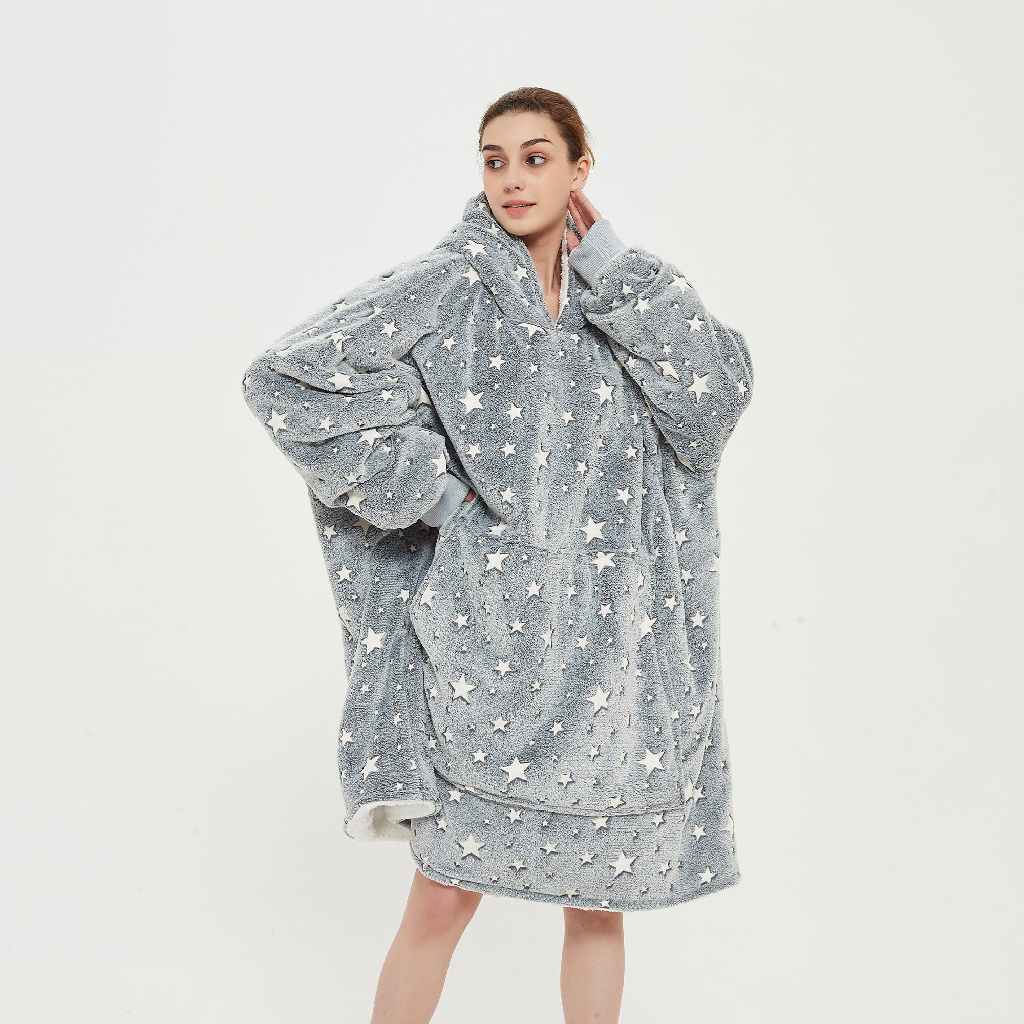 Snuggyz glow-in-the-dark stars hoodie blanket showing a soft, cozy hoodie with star patterns in a relaxed, comfortable setting.