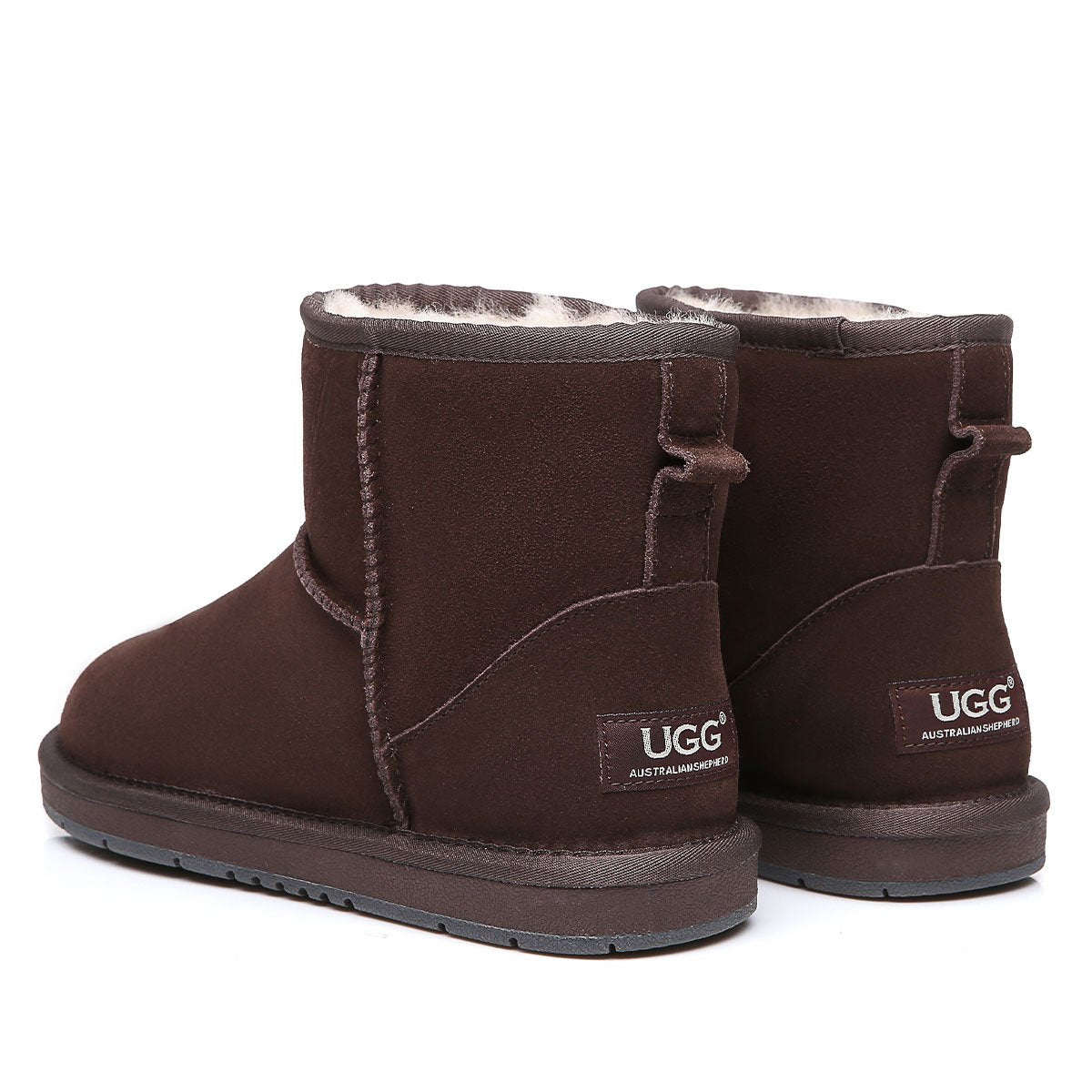 Mini classic suede UGG boots for women in tan, featuring plush sheepskin lining and durable rubber soles.