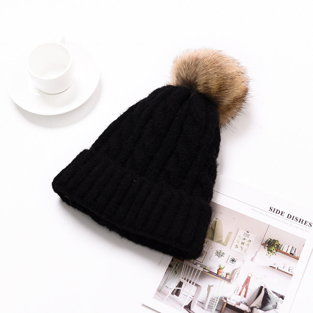 Snuggyz Pom Pom Beanie with a fluffy pom pom on top, cozy knit fabric, ideal for winter warmth and stylish cold-weather wear.