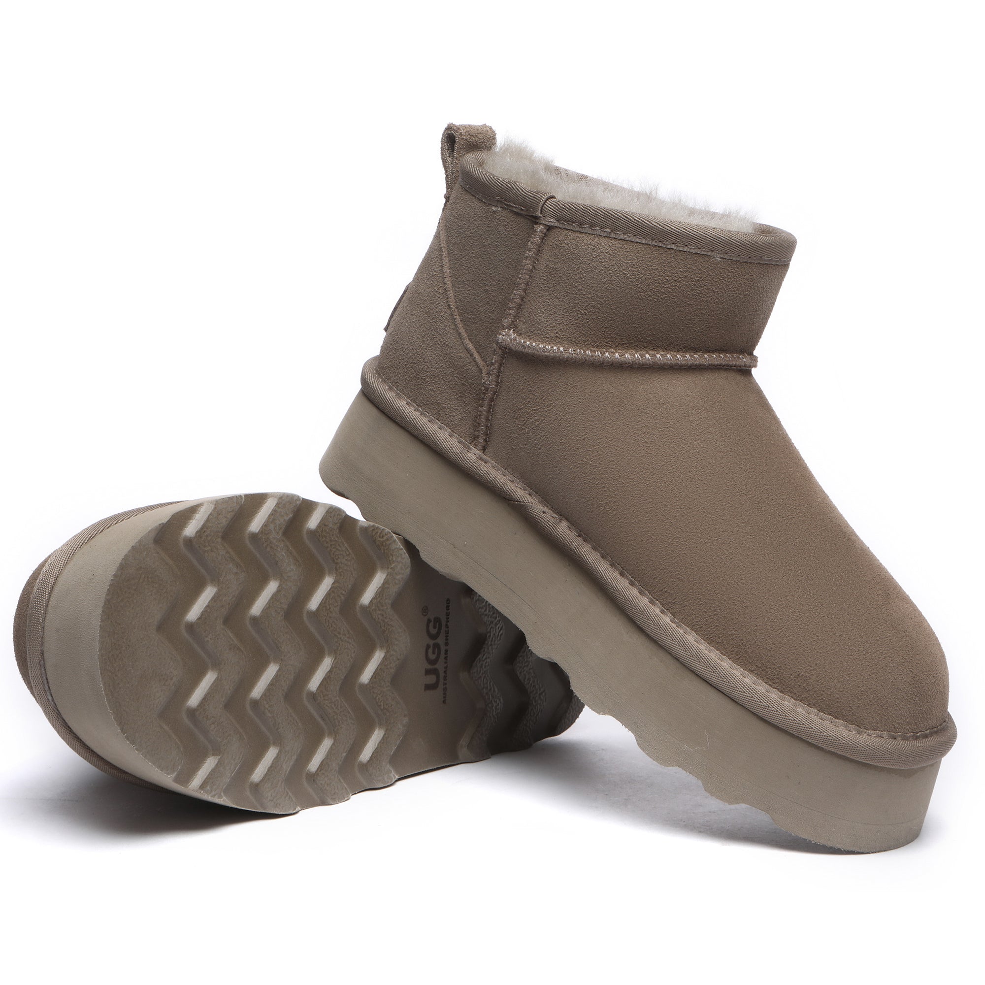 EverUgg Premium Platform Mini UGG Boots shown on a car seat, featuring cozy sheepskin lining and durable rubber soles.