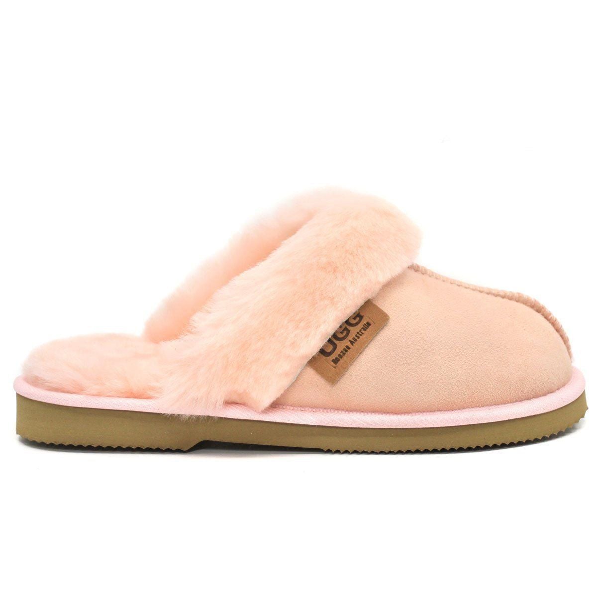 Light pink UGG premium women's slippers by Auzland, with soft plush interior and slip-on design for cozy comfort.