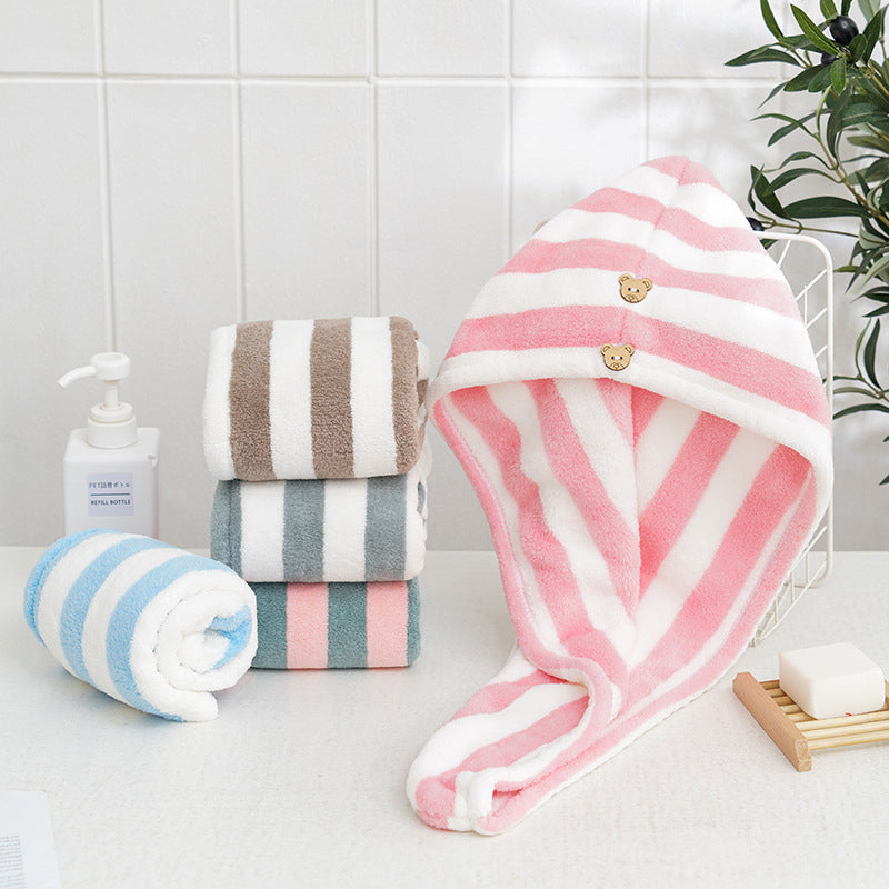 Pink and white Snuggyz® fast drying hair towel displayed on a hanger, showcasing its soft, lightweight fabric and quick-drying design.