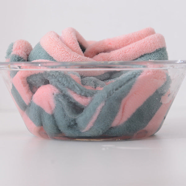 Pink and blue Snuggyz® fast drying hair towel shown folded with soft, absorbent fabric ideal for quick hair drying.
